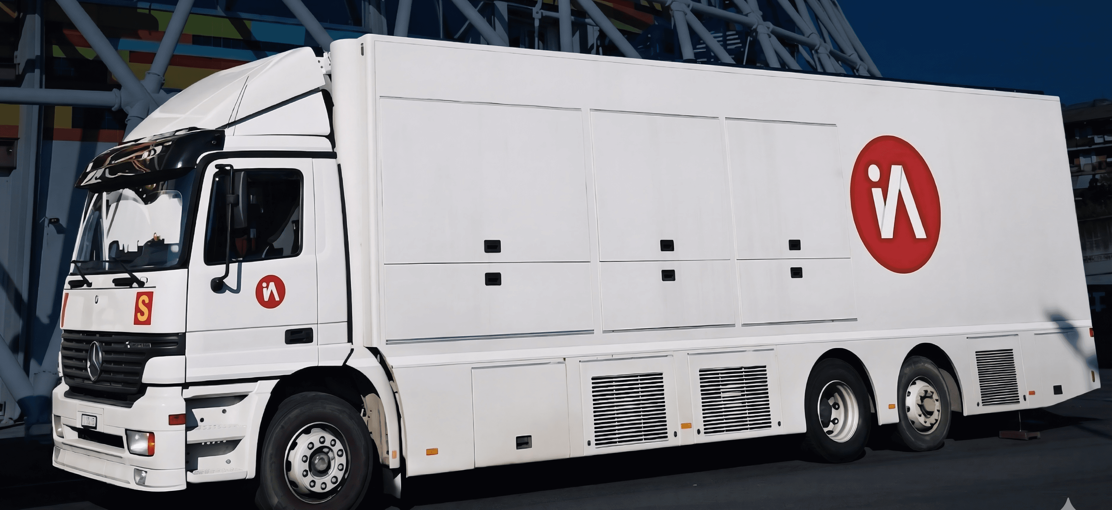 White Mercedes-Benz broadcast truck with red circular logos parked near a modern steel structure.
